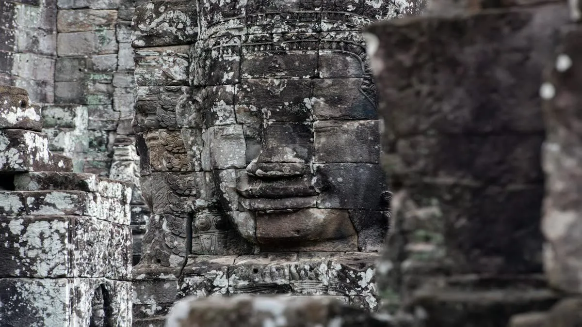 Ancient stone face carved at Bayon Temple, representing Khmer architectural mastery in Cambodia.