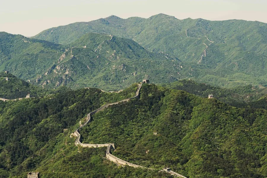 Great Wall of China winding through misty green mountains