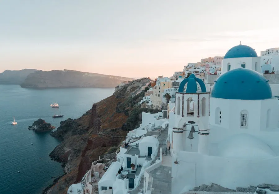 White-washed Santorini buildings cascading toward the deep blue Aegean