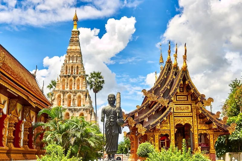 Golden temple spires against a blue sky in Bangkok