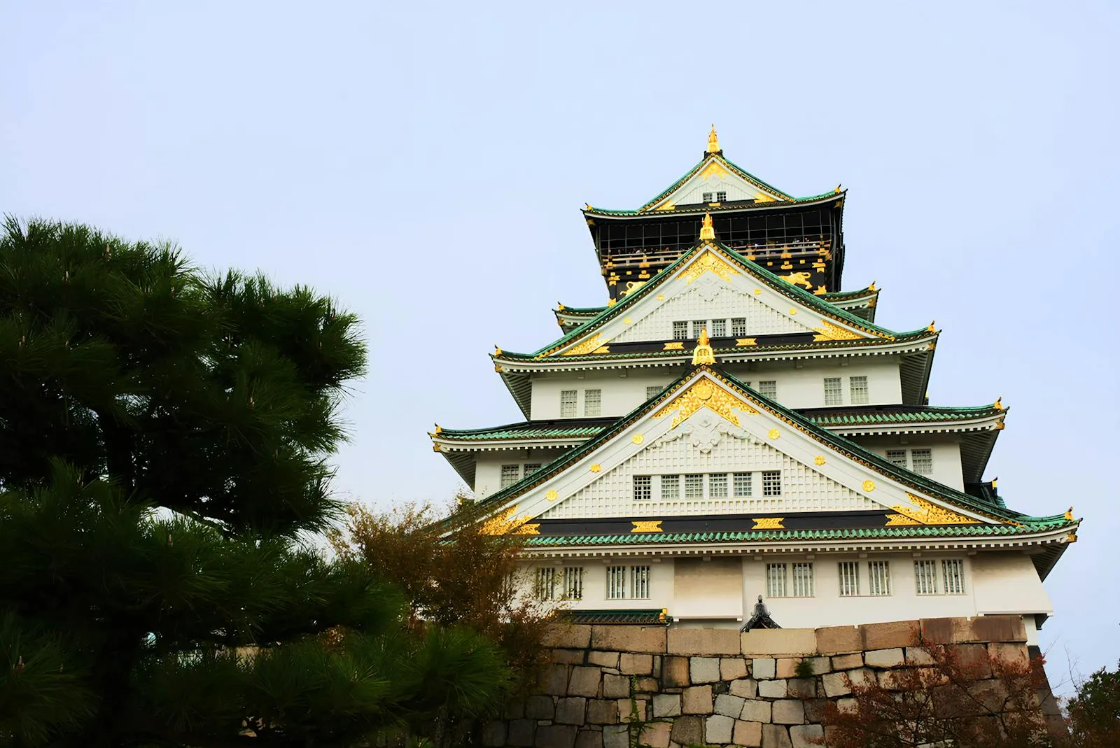 Majestic view of Osaka Castle with striking architecture set against a clear sky.