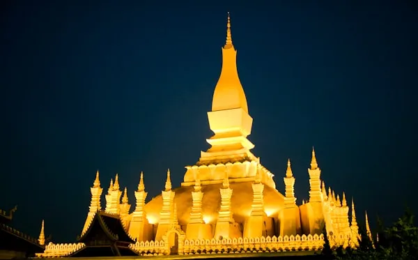 Historic white temple with golden details in Vientiane