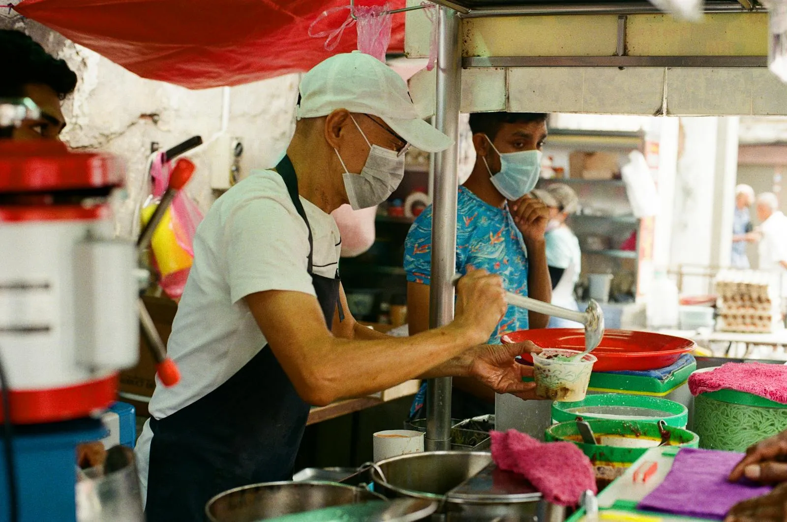 A bustling night market food stall showcasing an array of delicious fried snacks.