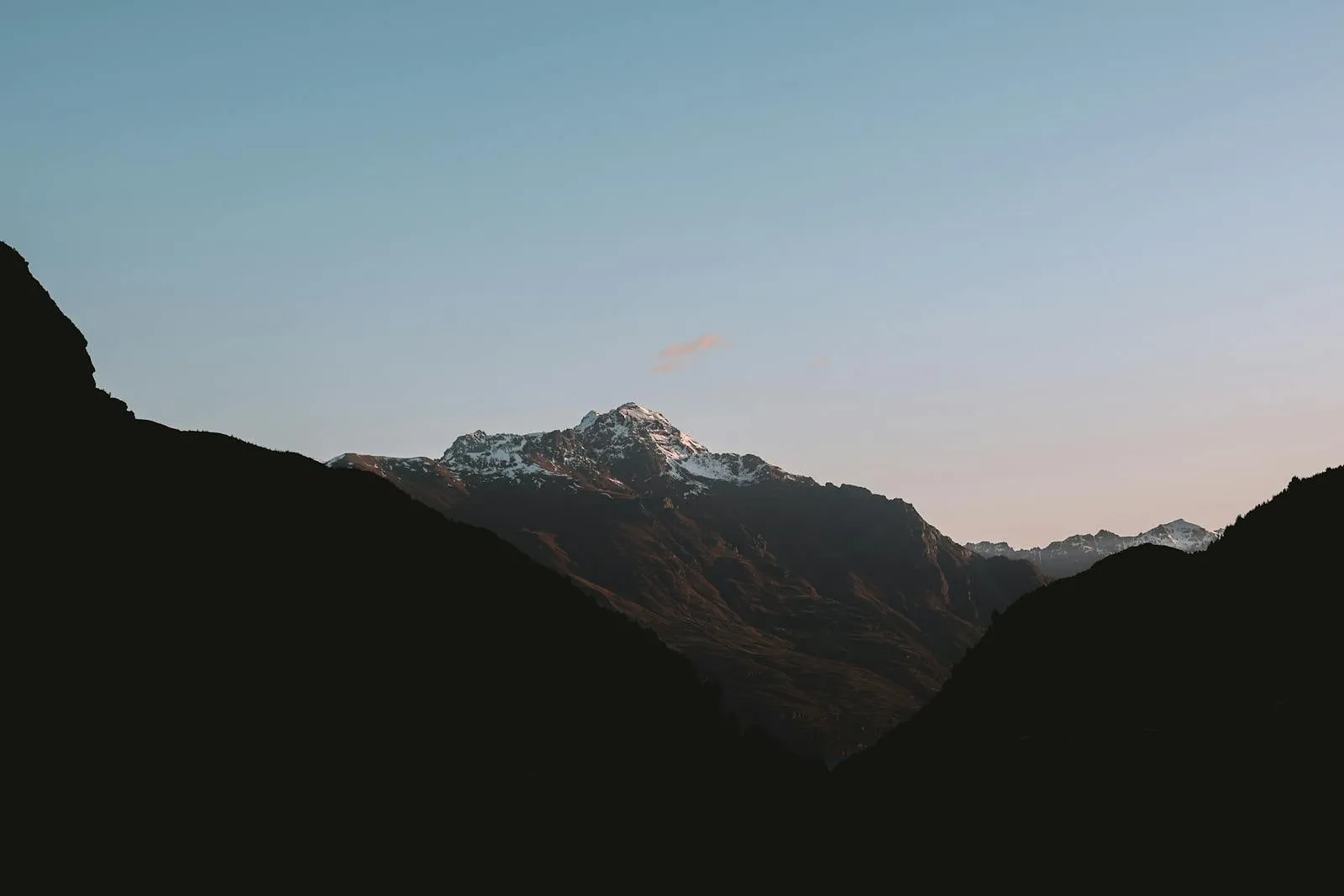 Tranquil view of the Southern Alps in New Zealand at dusk, capturing serene mountain landscapes.