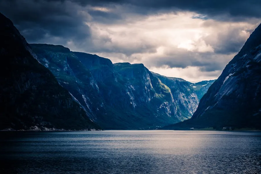 Norwegian fjord with steep green cliffs and calm blue water