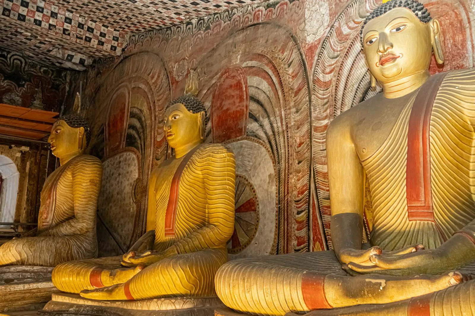 A captivating view of the intricately carved Buddha statues inside the historic Dambulla Cave Temple in Sri Lanka.