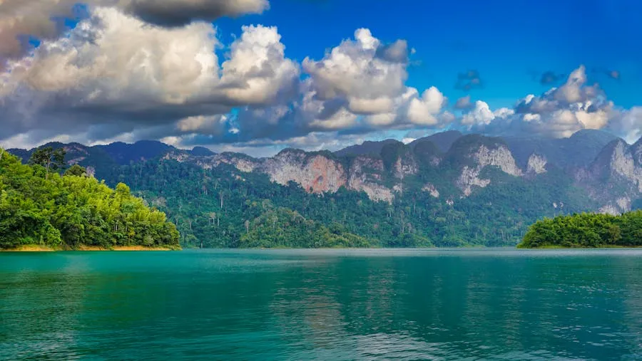 Misty karst peaks reflected in Cheow Lan Lake in Khao Sok