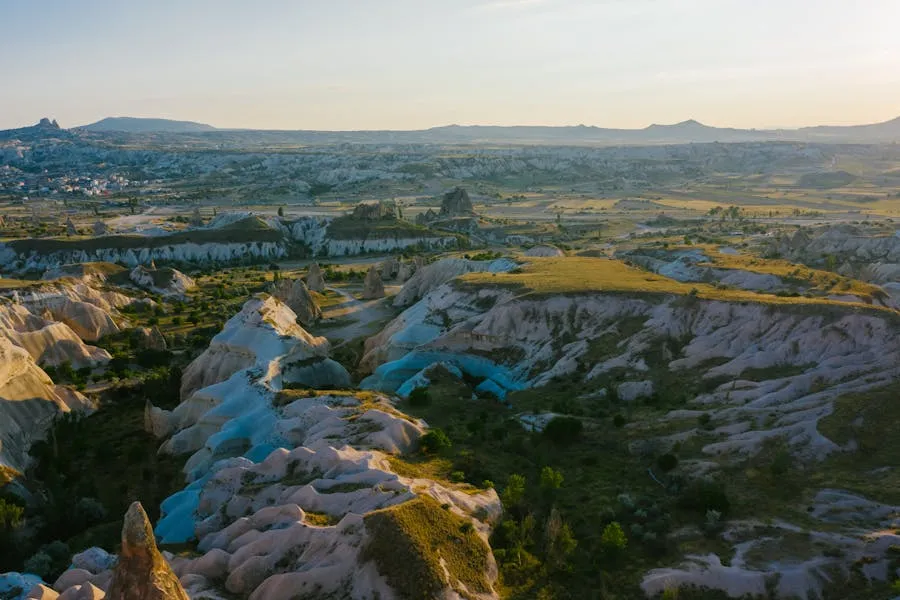 Hot air balloons floating over Cappadocia fairy chimneys at dawn