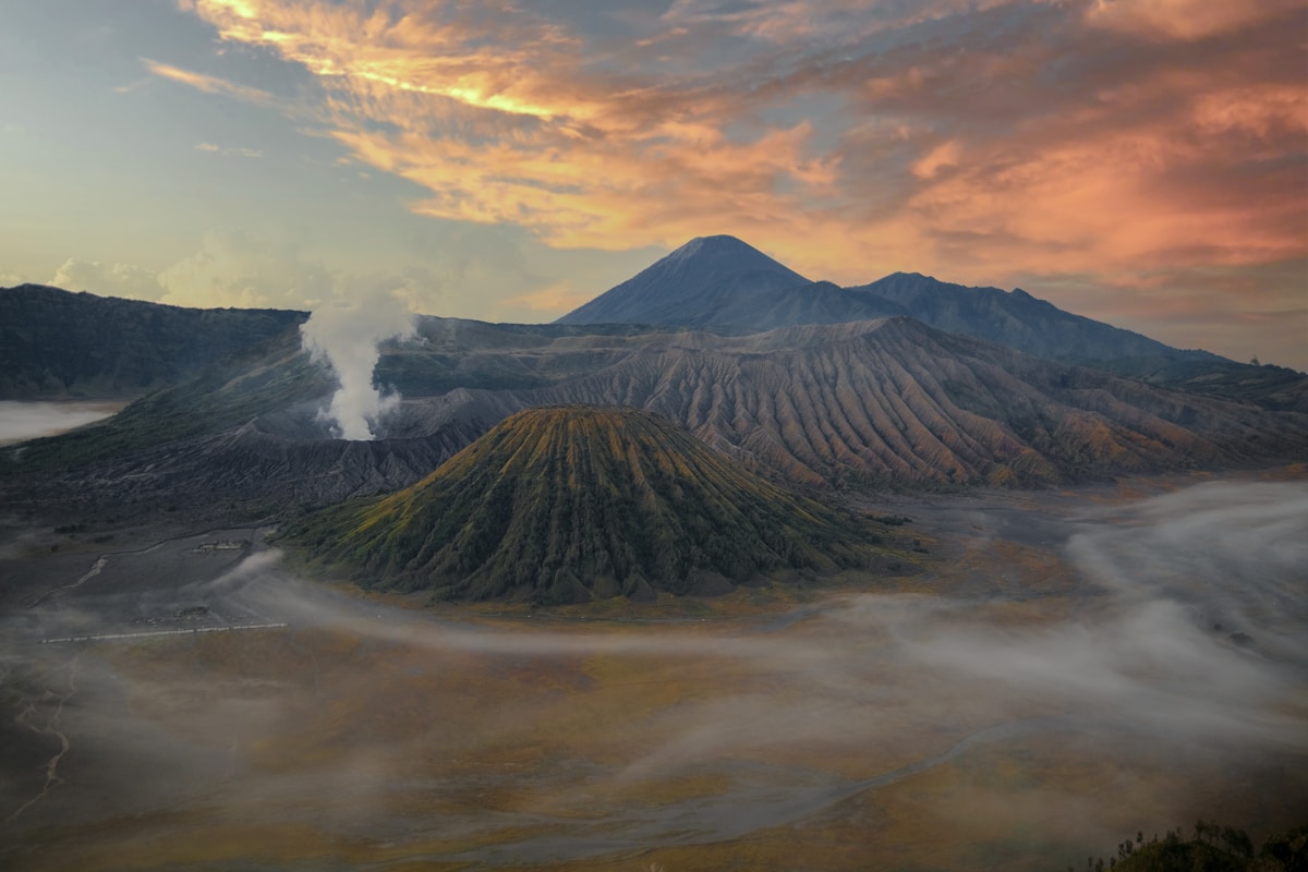 Mount Bromo volcano at sunrise with misty caldera