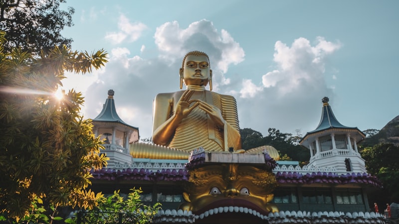 Ancient Buddhist cave temple with golden Buddha statues at Dambulla